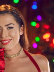 Sexy pornstar babe Melissa Moore posing her well-shaped body at the Christmas tree