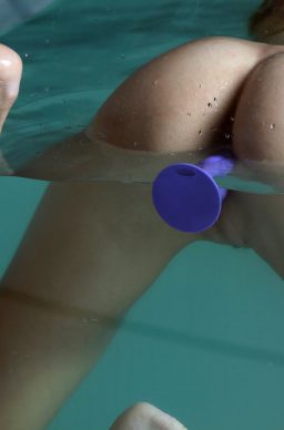 Wet teen babe Nancy A strips bikini bottom while posing in water